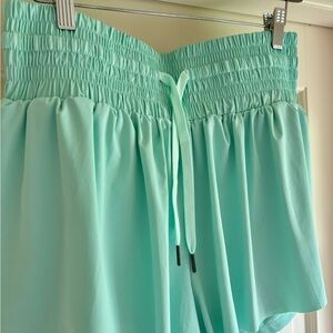 Never worn, mint green shorts with built-in spandex, size L